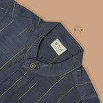 Boys ethnic silk shirt in navy with checked pattern paired with white and gold bordered dhoti, displayed flatlay style – festive wear from Boon Babies.
