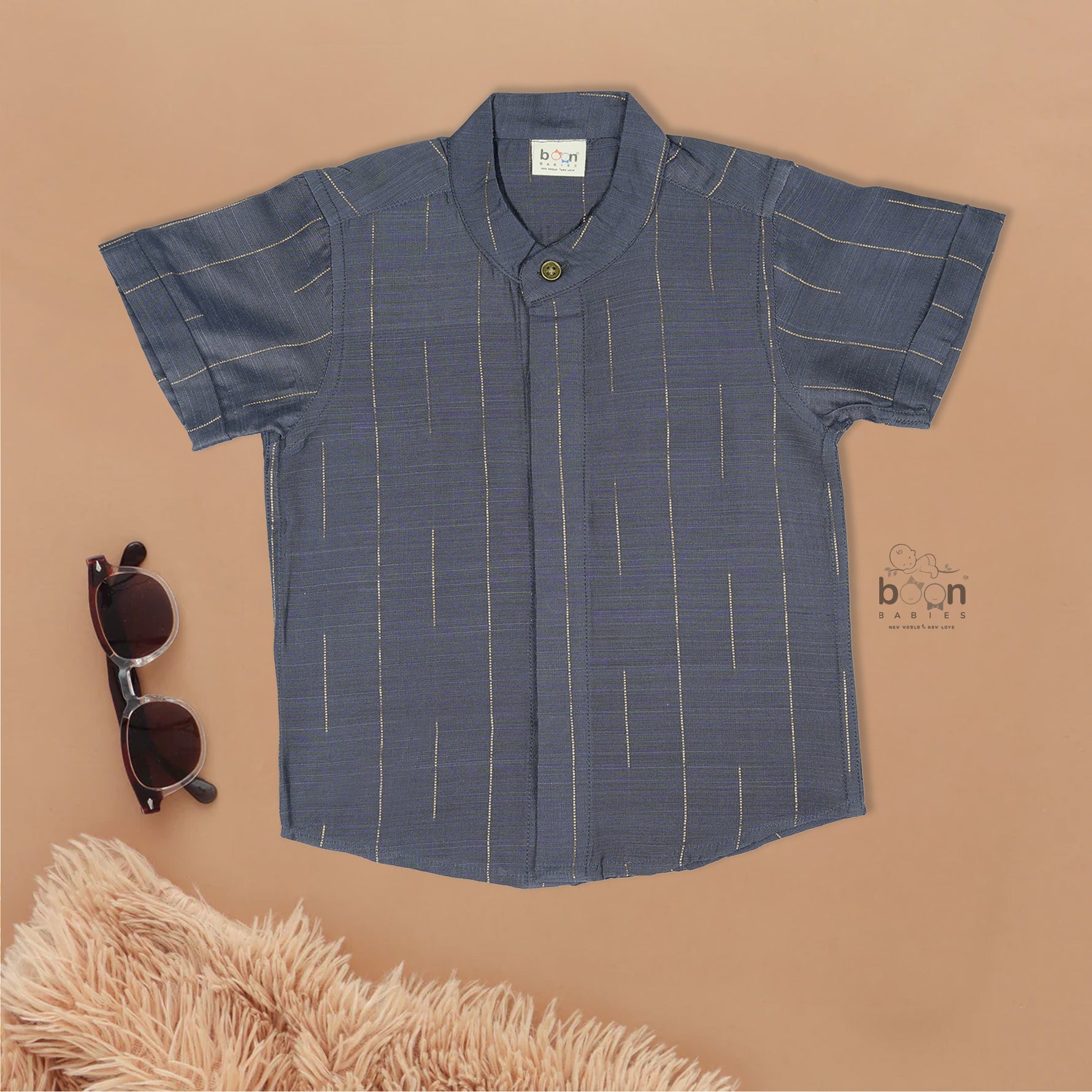 Boys ethnic silk shirt in navy with checked pattern paired with white and gold bordered dhoti, displayed flatlay style – festive wear from Boon Babies.
