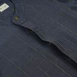 Boys ethnic silk shirt in navy with checked pattern paired with white and gold bordered dhoti, displayed flatlay style – festive wear from Boon Babies.
