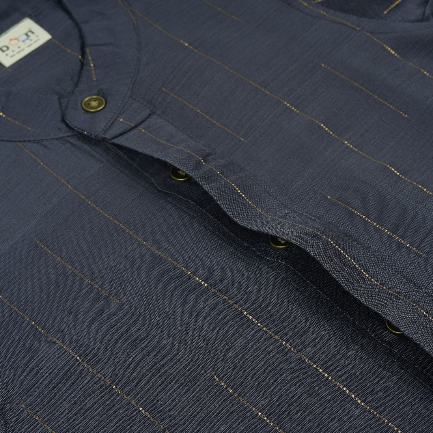 Boys ethnic silk shirt in navy with checked pattern paired with white and gold bordered dhoti, displayed flatlay style – festive wear from Boon Babies.
