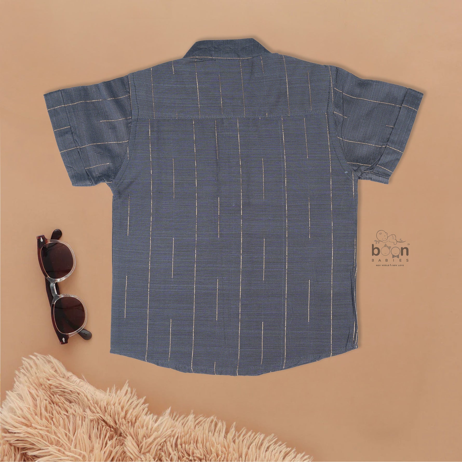 Boys ethnic silk shirt in navy with checked pattern paired with white and gold bordered dhoti, displayed flatlay style – festive wear from Boon Babies.
