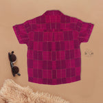 Magenta checked silk shirt with Chinese collar and white dhoti with gold border – boys festive ethnic outfit from Boon Babies.
