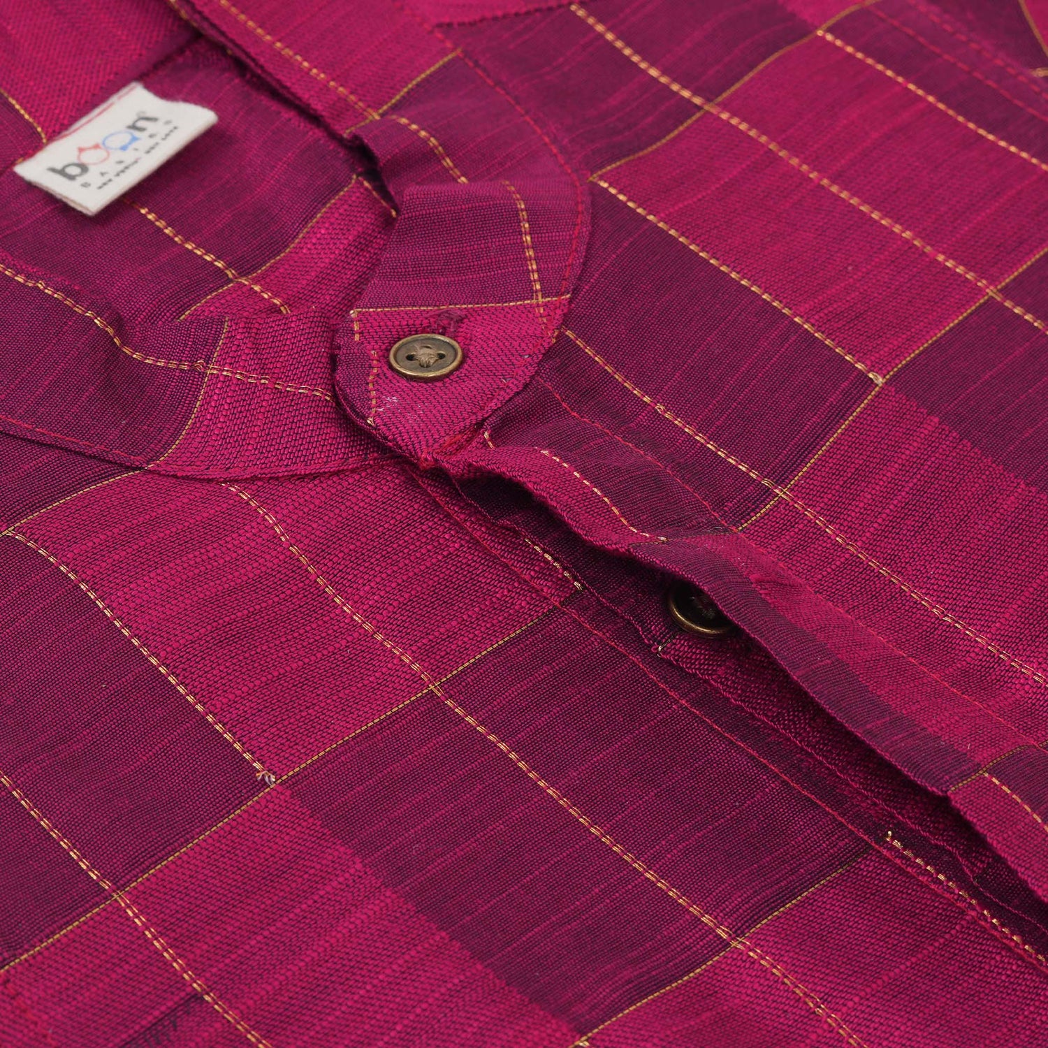 Magenta checked silk shirt with Chinese collar and white dhoti with gold border – boys festive ethnic outfit from Boon Babies.

