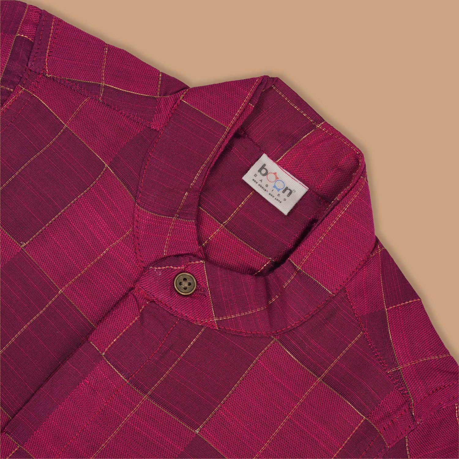 Magenta checked silk shirt with Chinese collar and white dhoti with gold border – boys festive ethnic outfit from Boon Babies.
