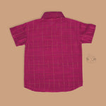 Boys festive outfit with maroon silk checked shirt and white dhoti with gold border – ethnic South Indian look from Boon Babies.
