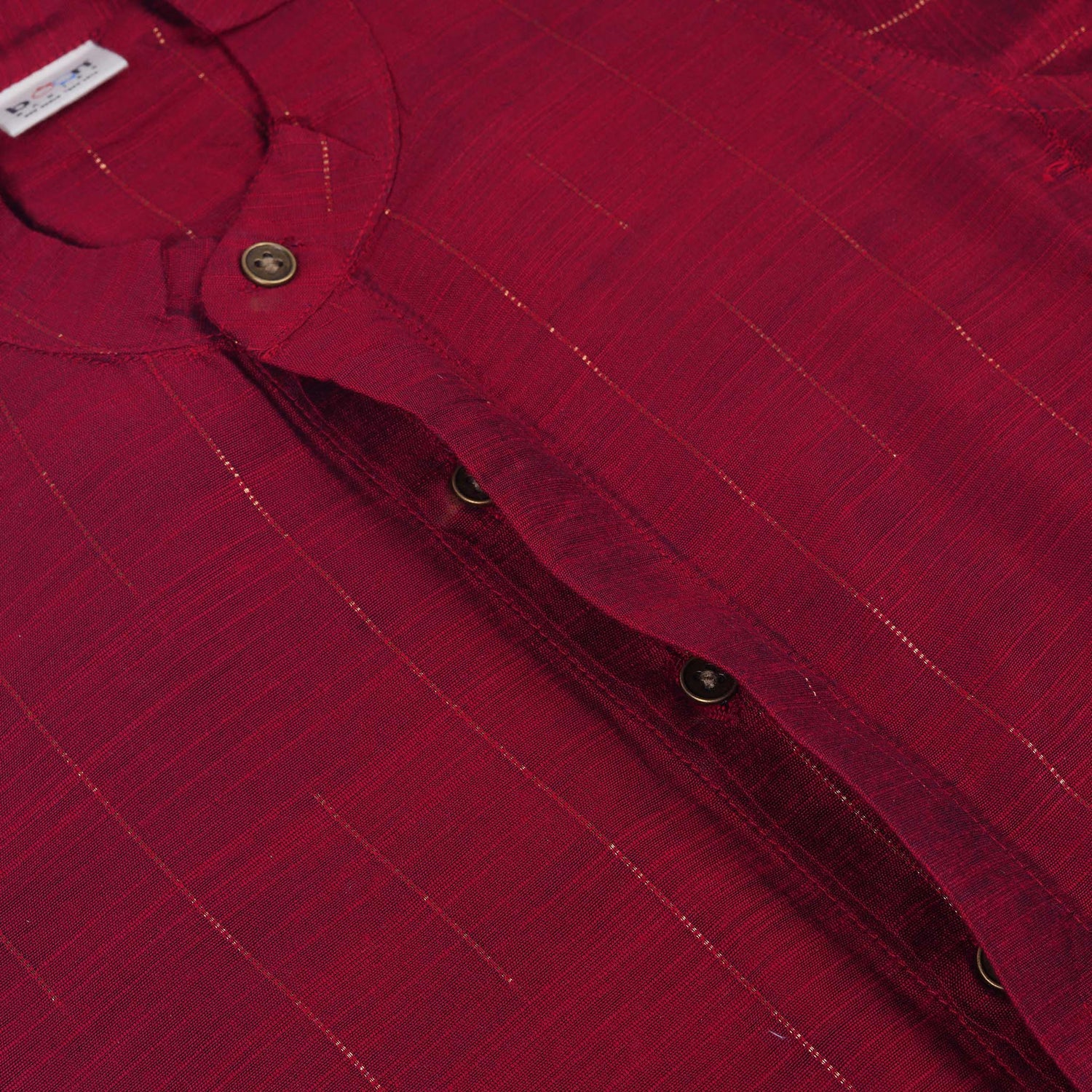 Maroon silk checked shirt with Chinese collar paired with golden border cream dhoti – traditional boys ethnic wear from Boon Babies for 6 months to 5 years.
