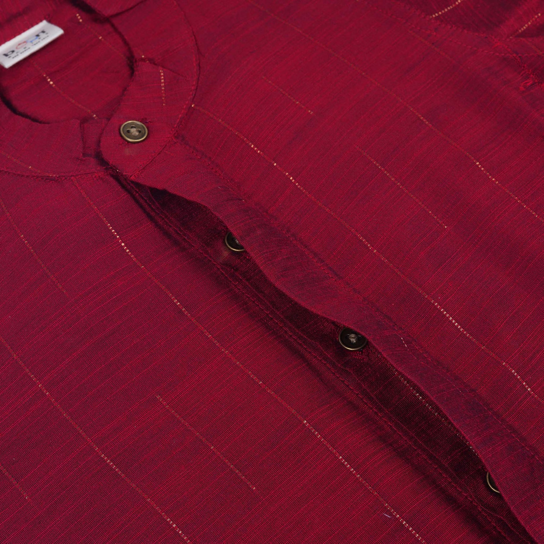 Maroon silk checked shirt with Chinese collar paired with golden border cream dhoti – traditional boys ethnic wear from Boon Babies for 6 months to 5 years.
