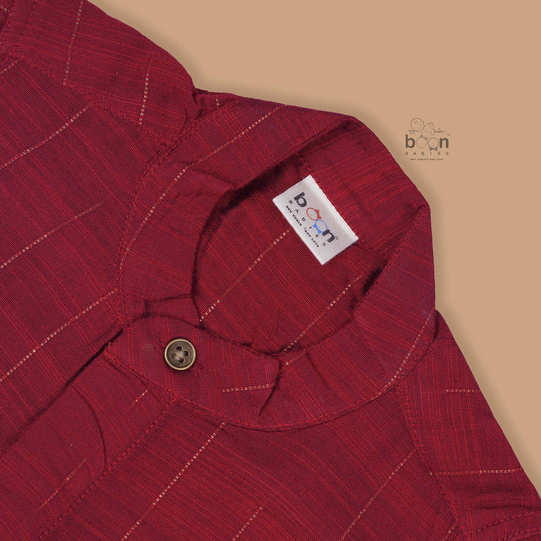 Maroon silk checked shirt with Chinese collar paired with golden border cream dhoti – traditional boys ethnic wear from Boon Babies for 6 months to 5 years.
