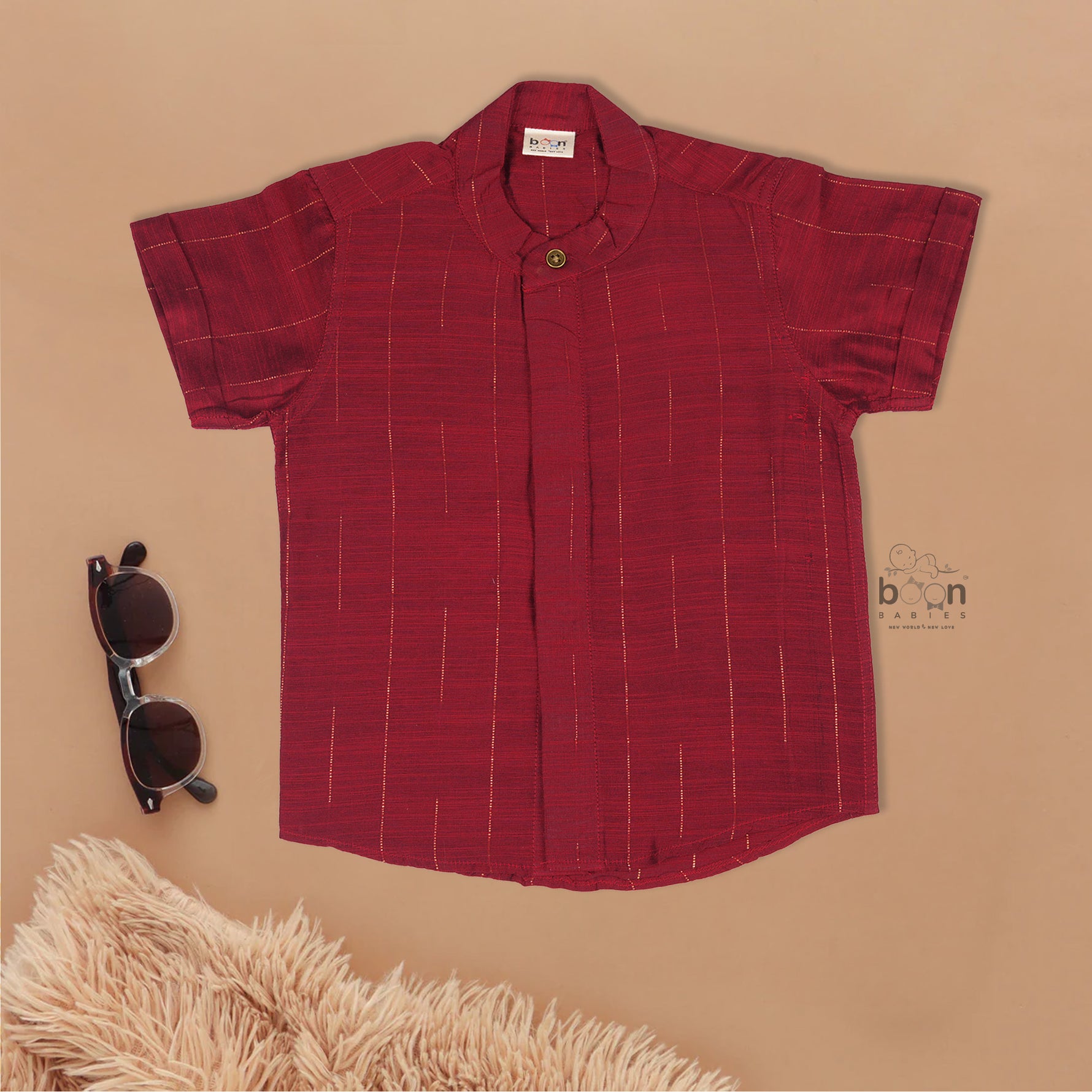 Maroon silk checked shirt with Chinese collar paired with golden border cream dhoti – traditional boys ethnic wear from Boon Babies for 6 months to 5 years.
