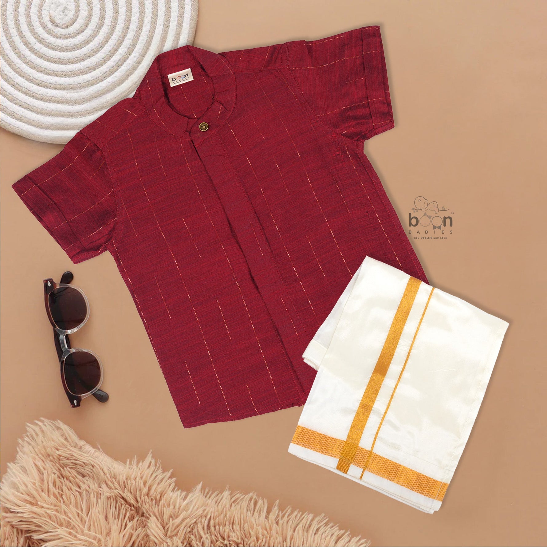 Maroon silk checked shirt with Chinese collar paired with golden border cream dhoti – traditional boys ethnic wear from Boon Babies for 6 months to 5 years.
