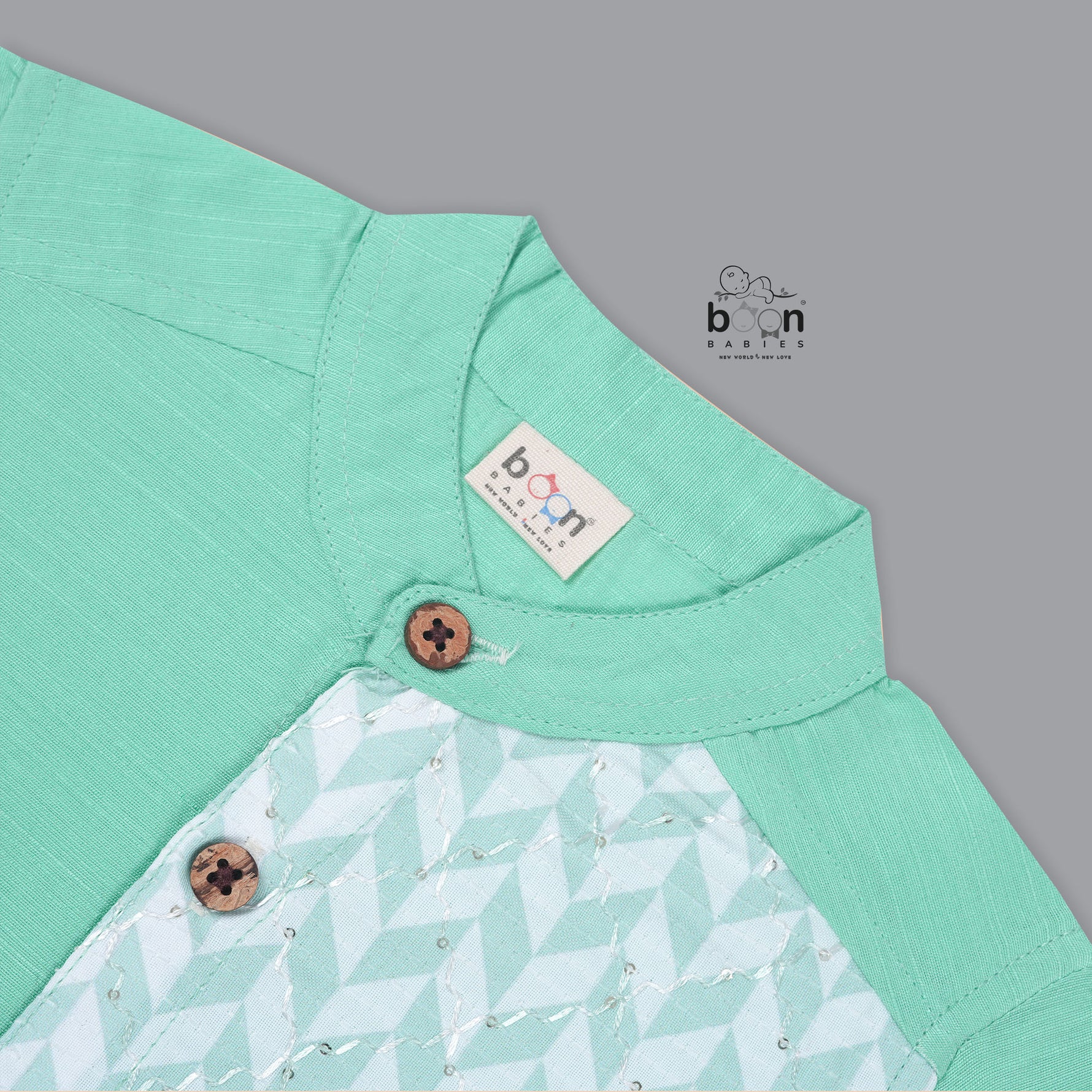 Boys’ mint green silk shirt with illustrated cow and palm tree print panel, paired with a cream silk pattu dhoti with golden border – Boon Babies ethnic set for toddlers.