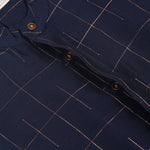 Navy blue checked silk shirt with Chinese collar and white dhoti with gold border – traditional South Indian festive outfit for boys by Boon Babies.
