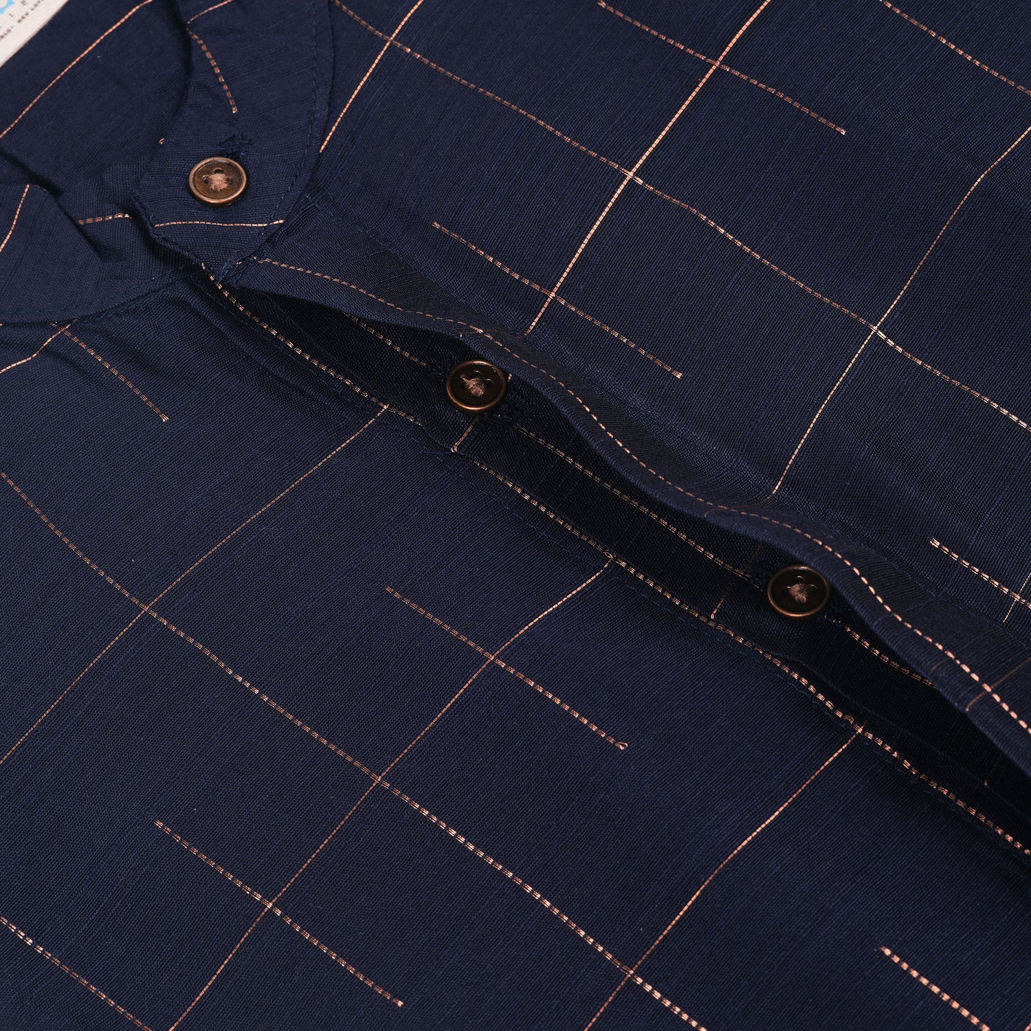 Navy blue checked silk shirt with Chinese collar and white dhoti with gold border – traditional South Indian festive outfit for boys by Boon Babies.
