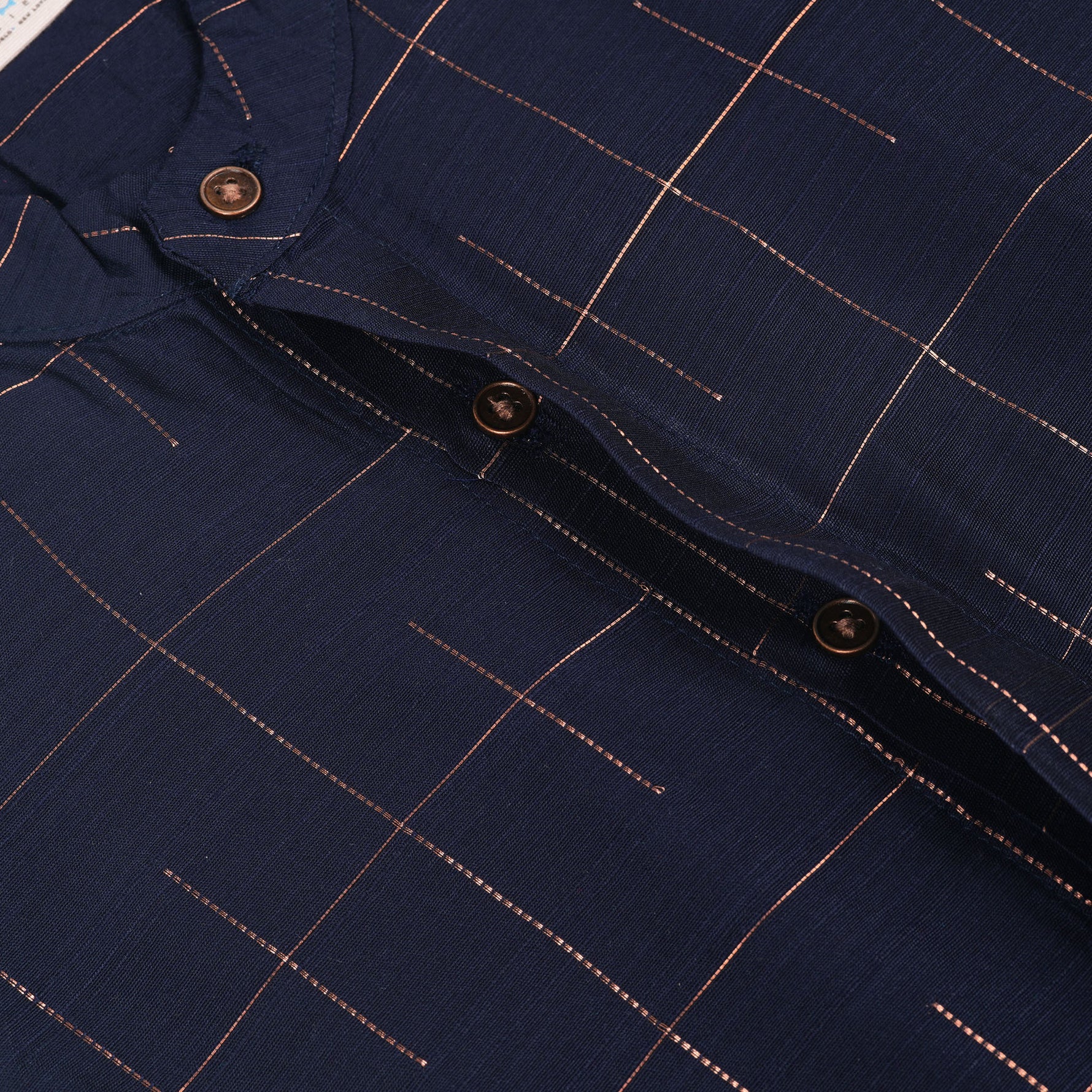 Navy blue checked silk shirt with Chinese collar and white dhoti with gold border – traditional South Indian festive outfit for boys by Boon Babies.
