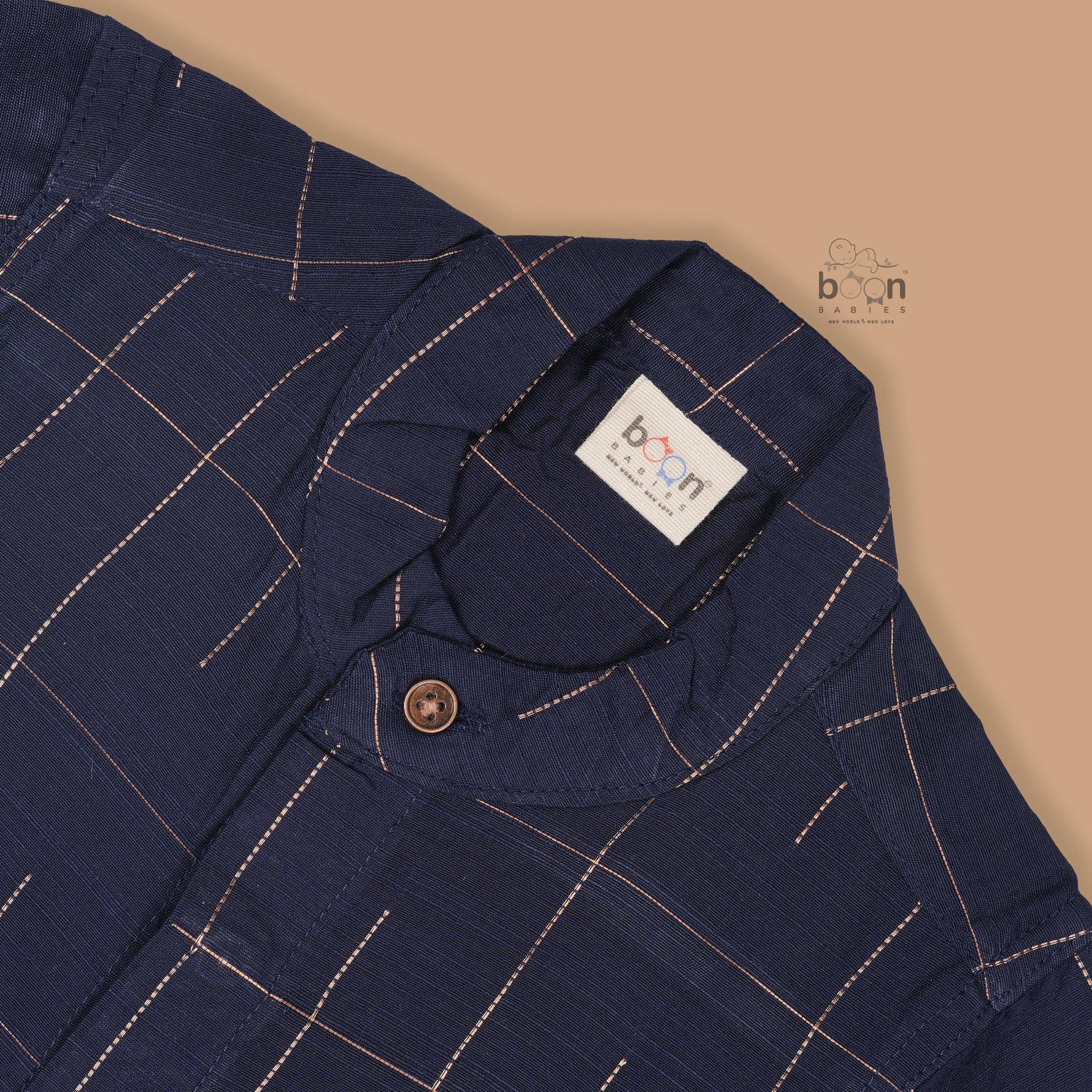 Navy blue checked silk shirt with Chinese collar and white dhoti with gold border – traditional South Indian festive outfit for boys by Boon Babies.
