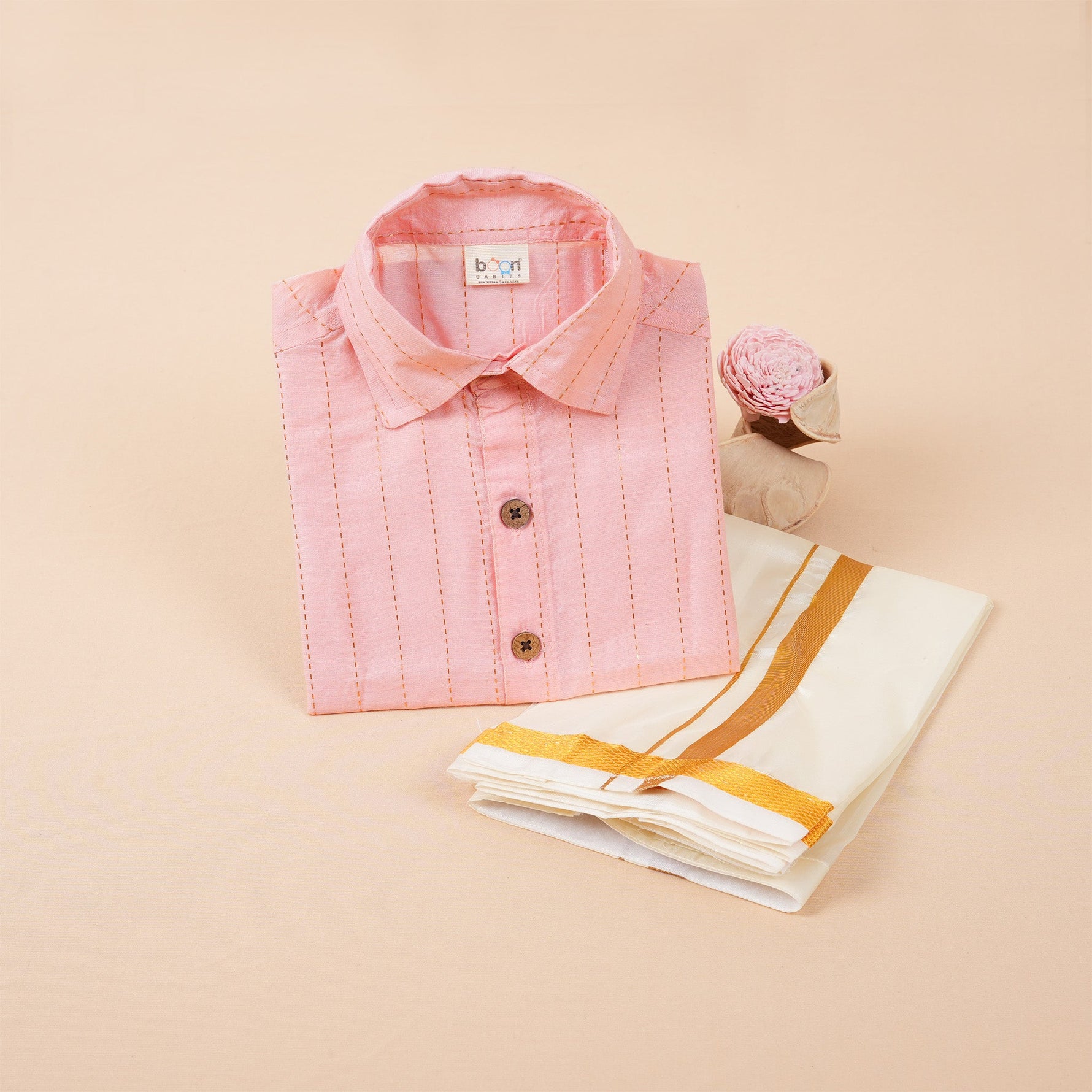 Peach pink silk shirt with gold lines and white pattu dhoti with golden border – boys’ traditional wear set from Boon Babies.
