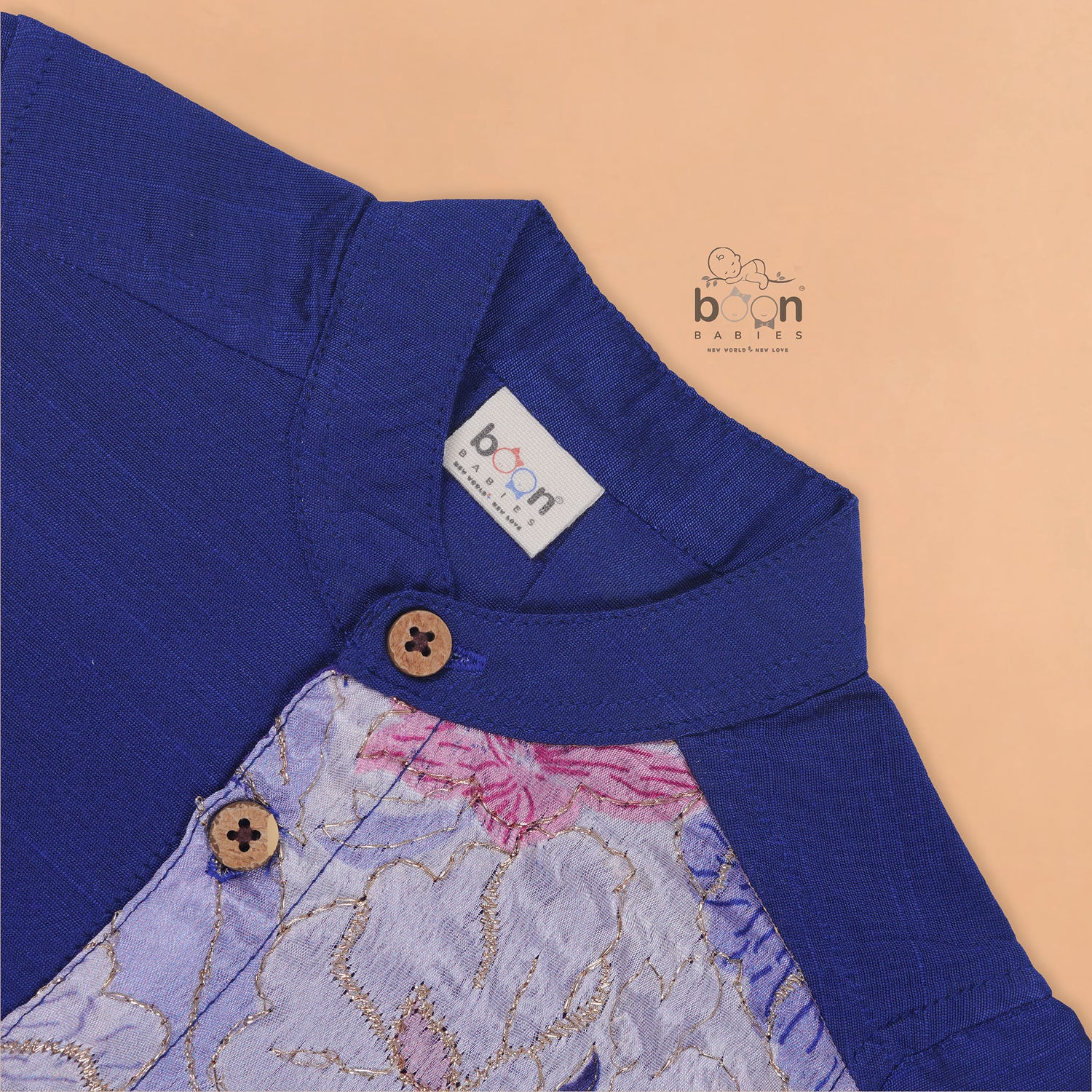 Royal blue silk panel shirt with floral embroidery paired with white pattu dhoti featuring a gold border – traditional festive outfit for boys by Boon Babies.
