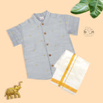 Boys’ traditional grey silk butta shirt with ivory dhoti & zari border. Elegant & comfortable festive wear for ages 6M–5Y.