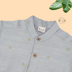 Boys’ traditional grey silk butta shirt with ivory dhoti & zari border. Elegant & comfortable festive wear for ages 6M–5Y.