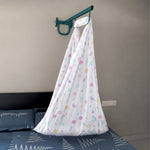 White cotton newborn baby cradle with printed circle design by Boon Babies, featuring a cozy, soft resting space for infants.