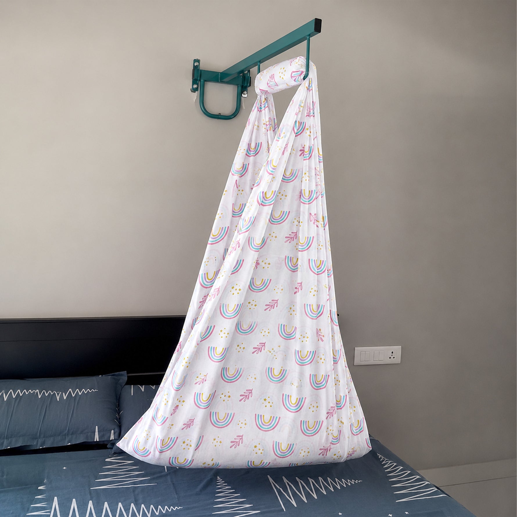 Printed newborn baby cotton cradle with white rainbow design by Boon Babies, showcasing soft fabric and cozy sleeping area.