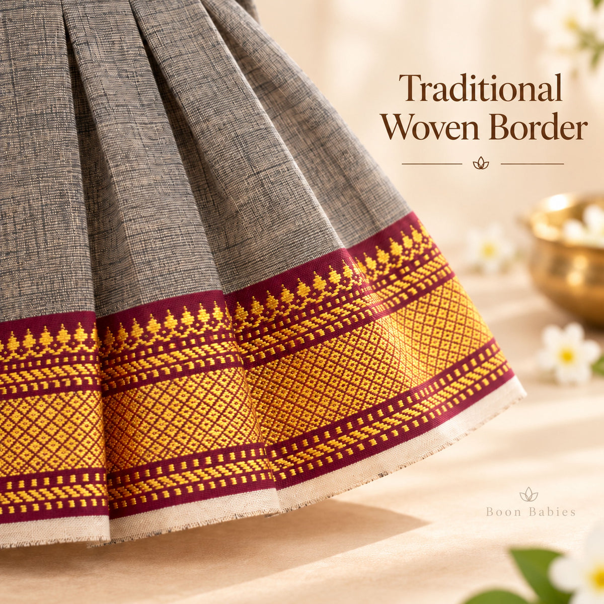 Traditional maroon and gold woven hem border detail on charcoal grey Mangalagiri cotton baby girl frock