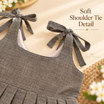Soft tie-up shoulder strap detail on charcoal grey Mangalagiri cotton baby girl frock