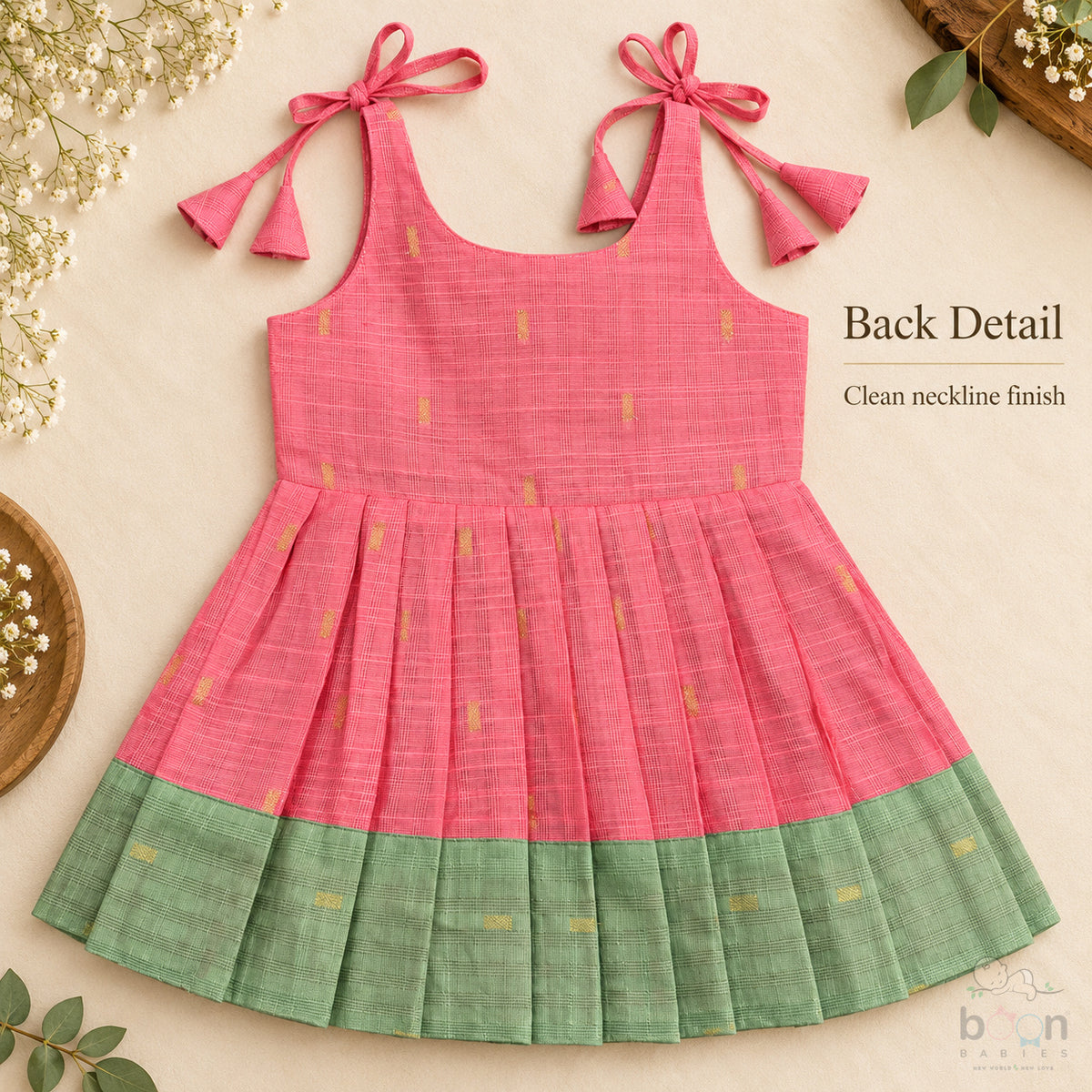 Coral pink tissue silk cotton baby girl knot frock back view with shoulder tie fastening and sage green border