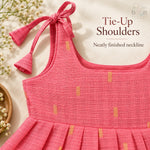 Tie-up shoulder and neatly finished neckline detail on coral pink tissue silk cotton baby girl frock
