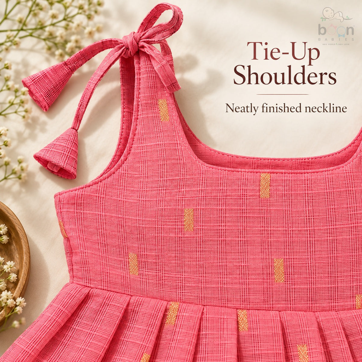 Tie-up shoulder and neatly finished neckline detail on coral pink tissue silk cotton baby girl frock