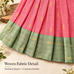 Woven tissue silk cotton texture, defined pleats and sage green contrast border on coral pink baby girl knot frock