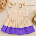 Cream tissue silk cotton baby girl knot frock back view with shoulder tie fastening and purple border