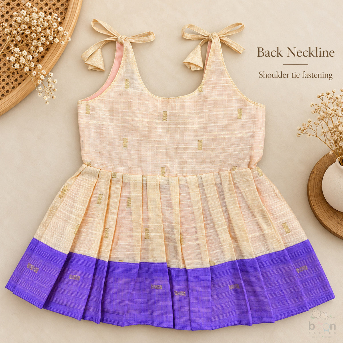 Cream tissue silk cotton baby girl knot frock back view with shoulder tie fastening and purple border