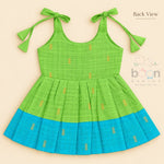 Green tissue silk cotton baby girl knot frock back view with tie-up shoulders, pleated skirt and turquoise border