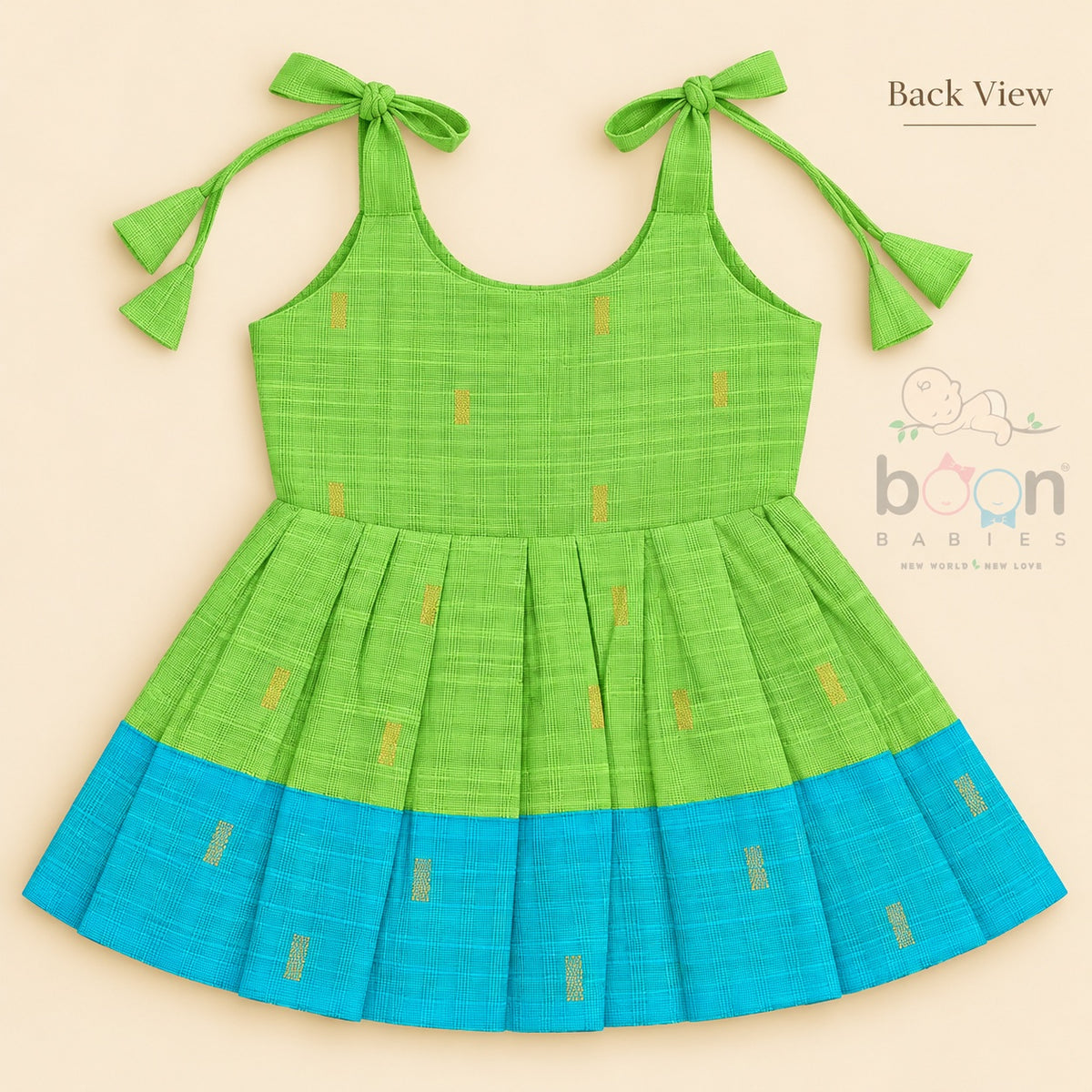 Green tissue silk cotton baby girl knot frock back view with tie-up shoulders, pleated skirt and turquoise border
