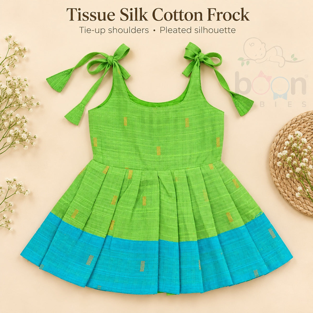 Green tissue silk cotton baby girl knot frock front view with tie-up shoulders, pleated skirt and turquoise border