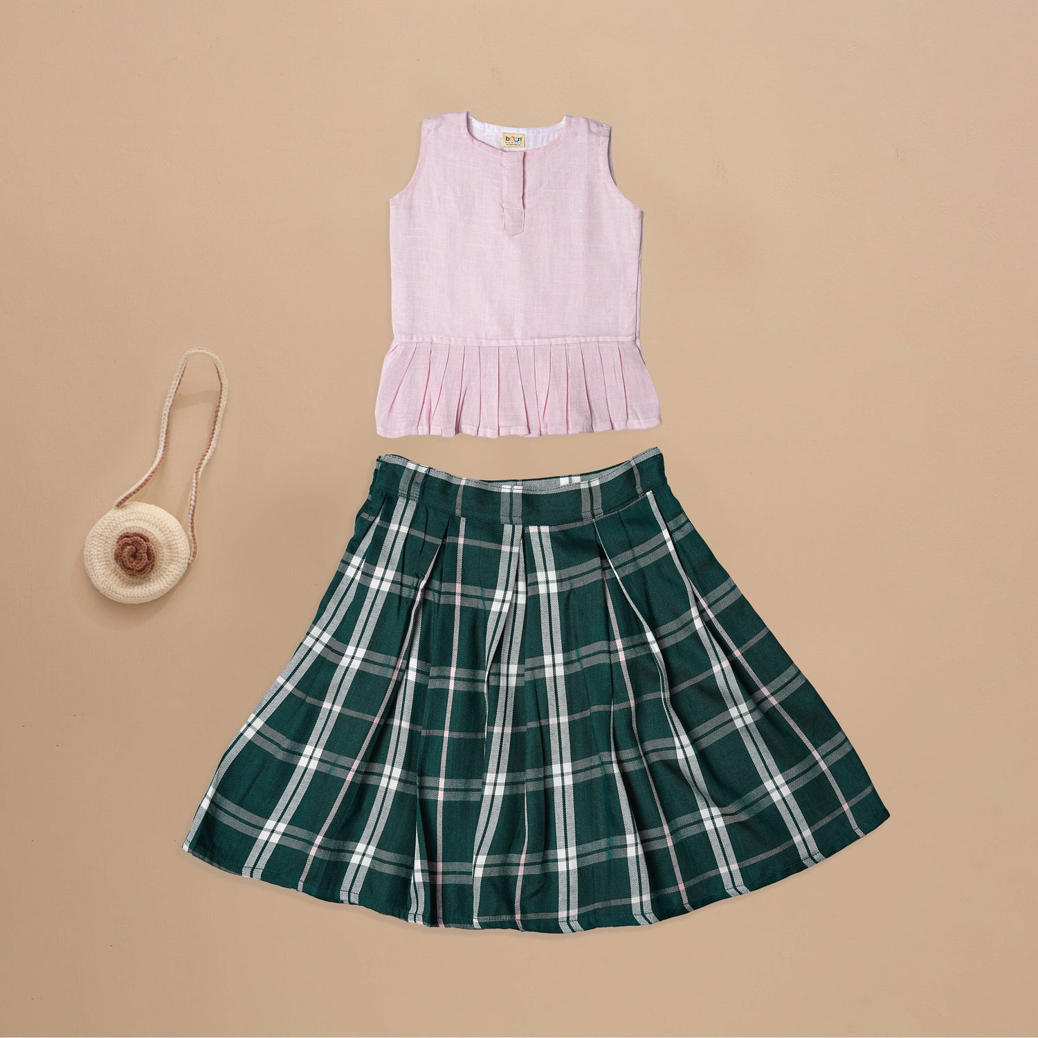 Soft Elegance: Sleeveless Pink Peplum and Skirt Set