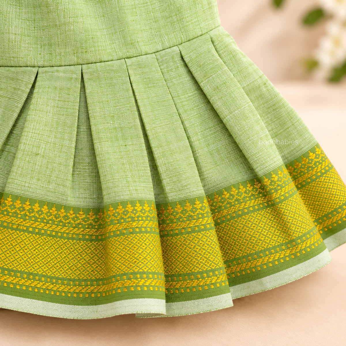 Pleated skirt detail on pastel green Mangalagiri cotton baby girl frock