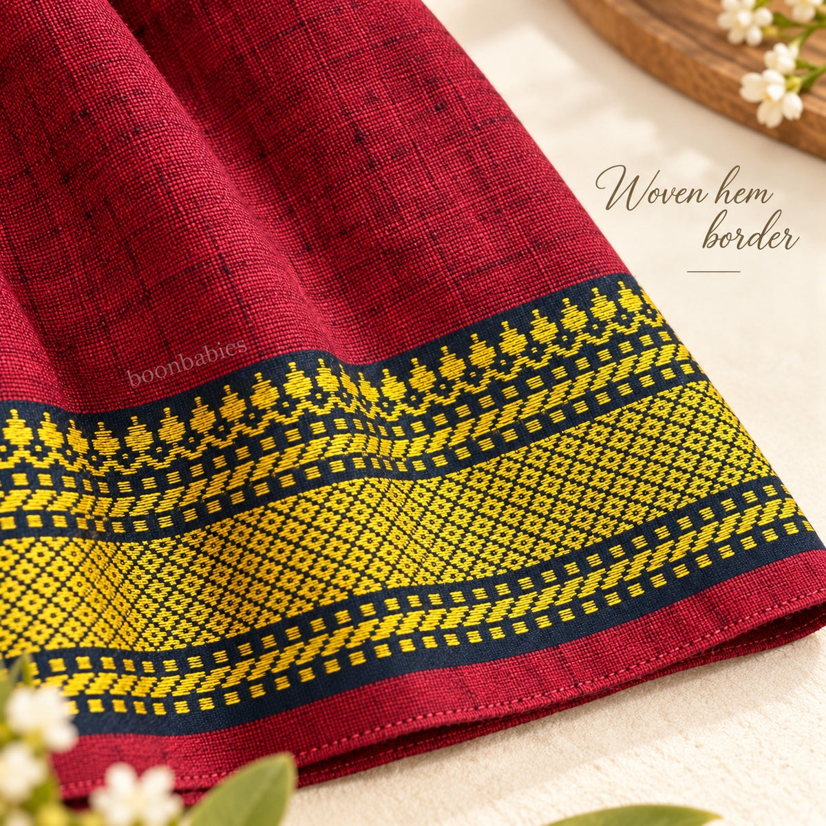 Woven navy and yellow hem border detail on maroon Mangalagiri cotton baby girl frock