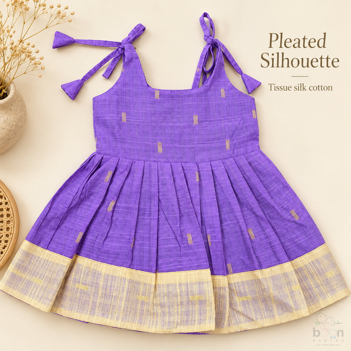 Purple tissue silk cotton baby girl knot frock front view with tie-up shoulders, pleated skirt and cream gold border
