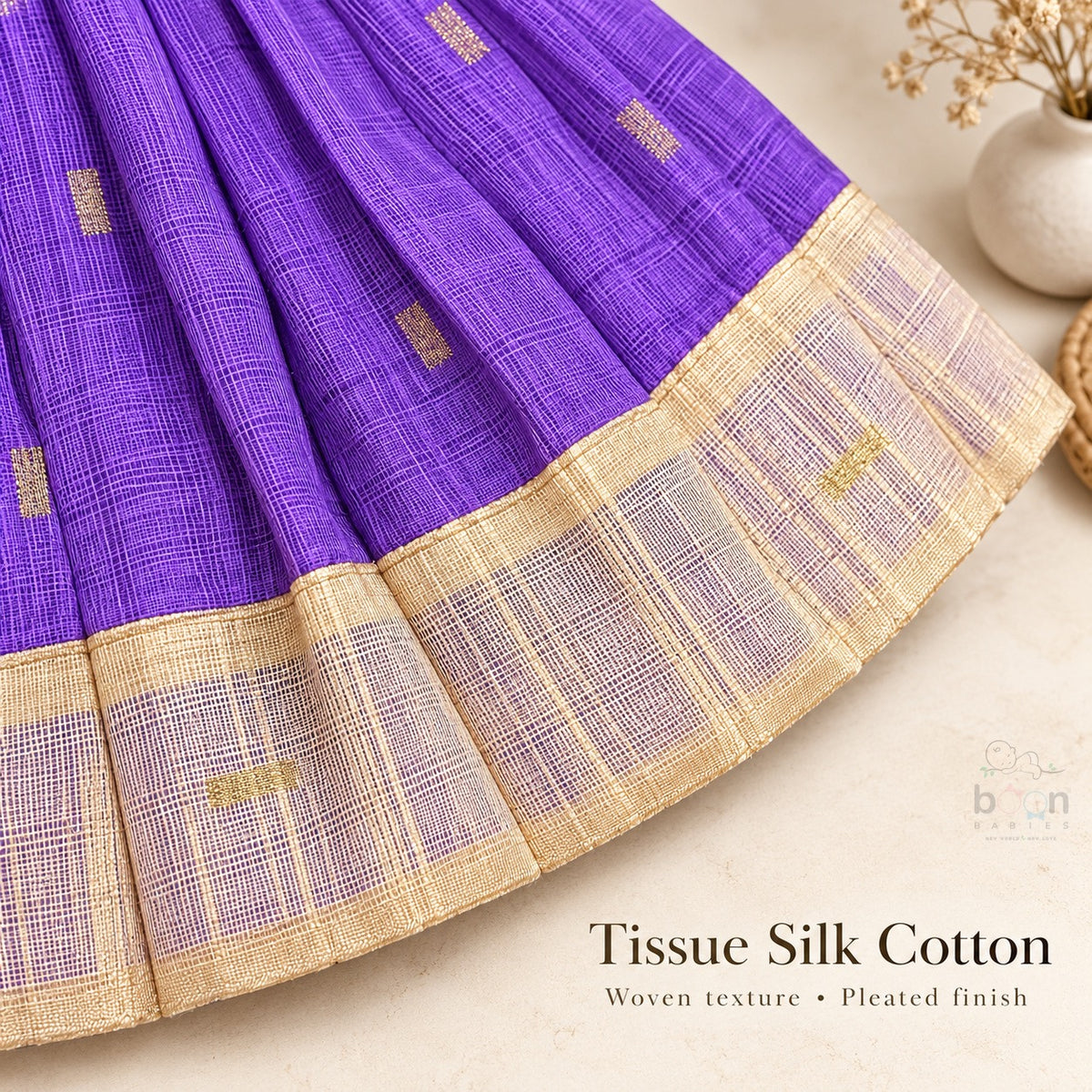 Woven tissue silk cotton texture, pleated skirt and cream gold border detail on purple baby girl knot frock