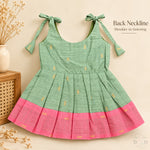 Sage green tissue silk cotton baby girl knot frock back view with shoulder tie fastening and pink border
