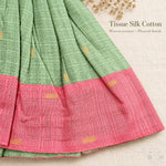 Woven tissue silk cotton texture, pleated skirt and pink border detail on sage green baby girl knot frock