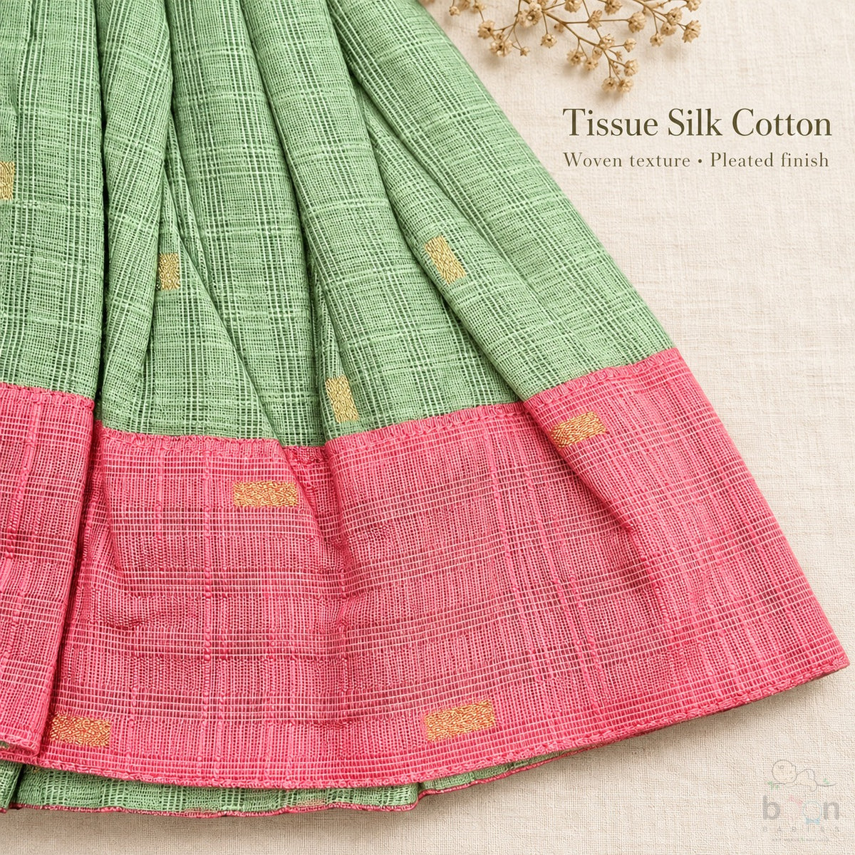 Woven tissue silk cotton texture, pleated skirt and pink border detail on sage green baby girl knot frock