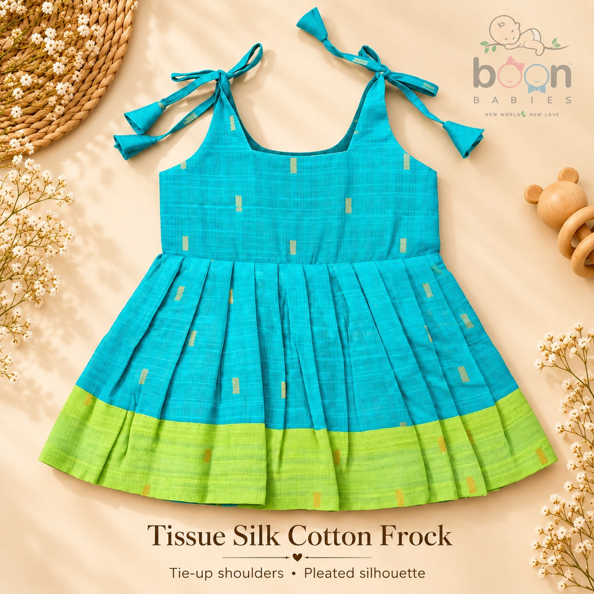 Turquoise tissue silk cotton baby girl knot frock front view with tie-up shoulders, pleated skirt and lime green border